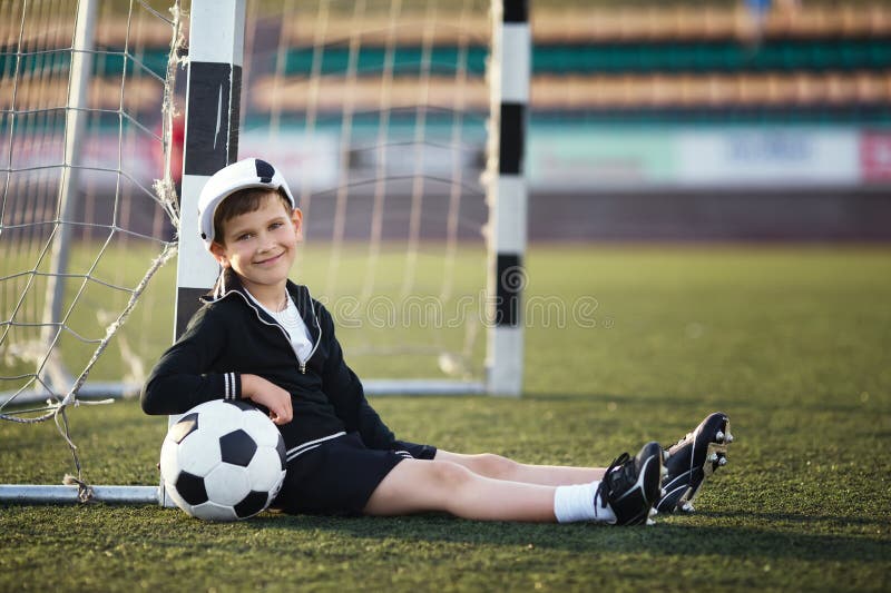 Little boy plays football