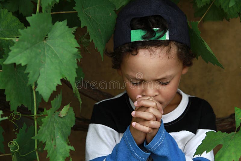 Little boy praying to God with hands held together stock photo royalty free stock images Little boy praying to God with hands held together stock photo royalty free stock images