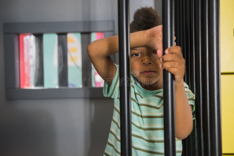 Kid Prisoner Try To Escape from Jail. Stock Image - Image of