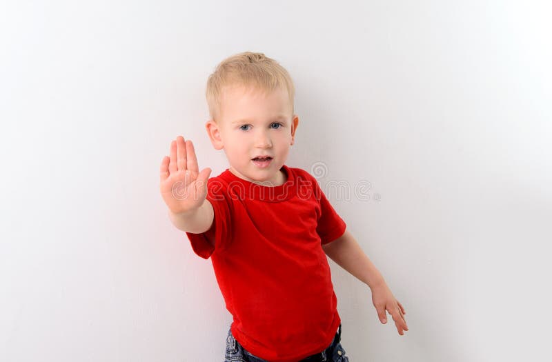 Little boy in red shirt showing stop sign stock photos Little boy in red shirt showing stop sign stock photos