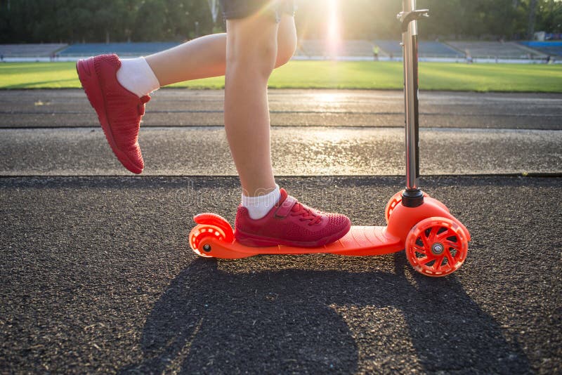 Little boy is riding scooter. Seasonal child activity sport. Healthy outdoor activity. Active leisure and outdoor sport for