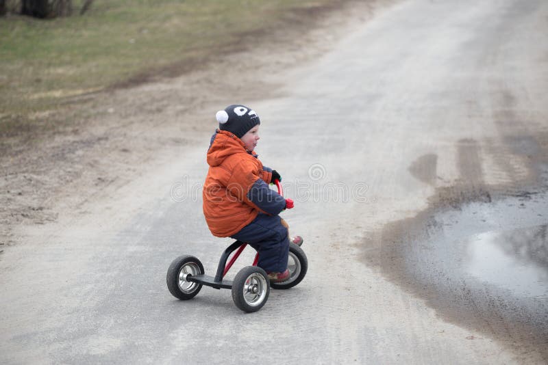 The Little Boy is Riding a Tricycle Stock Image Image of cheerful