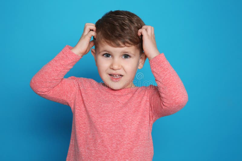 Little Boy Scratching Head on Color Background Stock Photo Image of