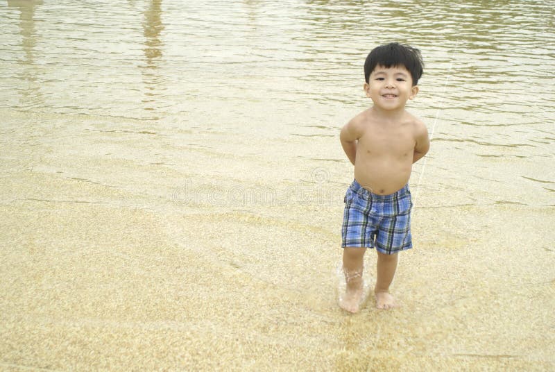 Little boy in shallow water royalty free stock image