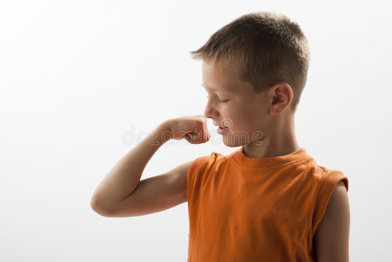 Little boy showing his muscles