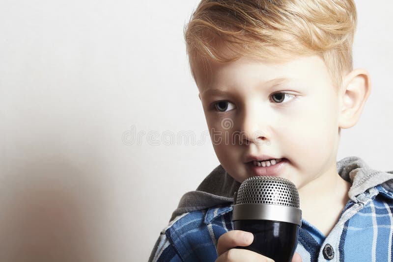 Little boy singing in microphone.child in karaoke.music