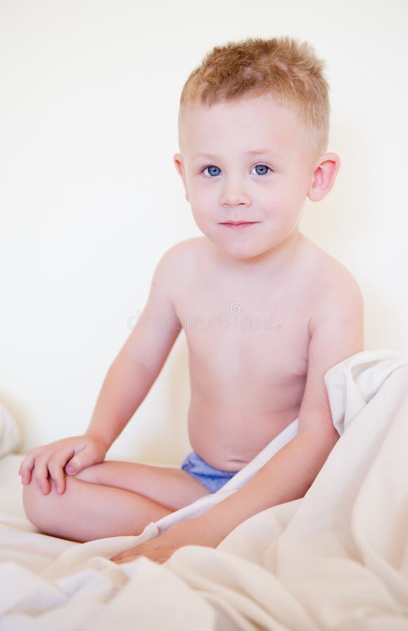 Little boy sits in a bed