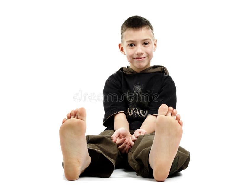 Little boy sitting barefoot