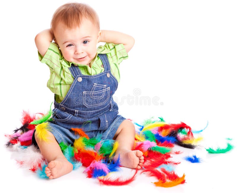 Little boy is sitting on a flow with feathers