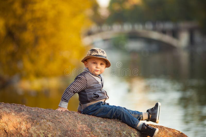 Photo of a young curly sad teenage guy posing isolated over grey wall  background Stock Photo - Alamy