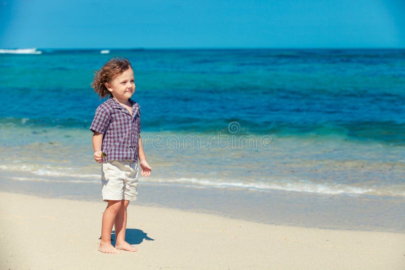 Little boy standing on the beach