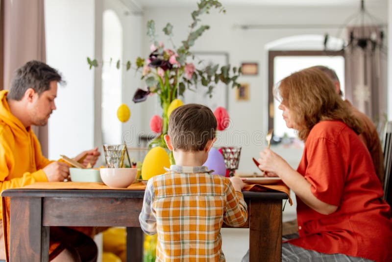 Little boy standing at the Easter table at home royalty free stock photo