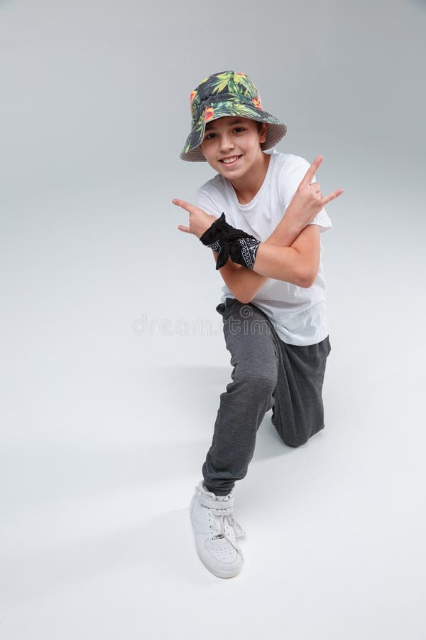 Man making rocker gesture, on white background. Young adult young man  sticking out his tongue with rocker pose, hand with rock and roll sign  Stock Photo - Alamy
