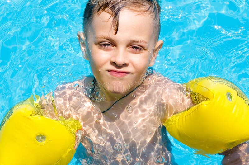 Little Boy Swimming In The Water With Armbands Stock Image Image Of