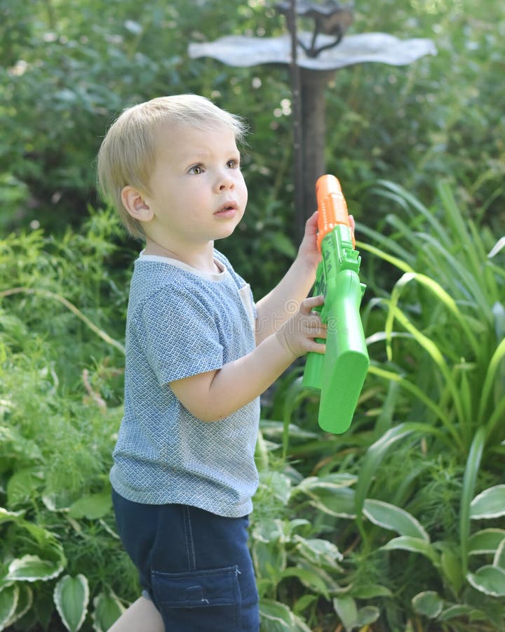 Little Boy with Toy Gun stock image. Image of shorts 93986813