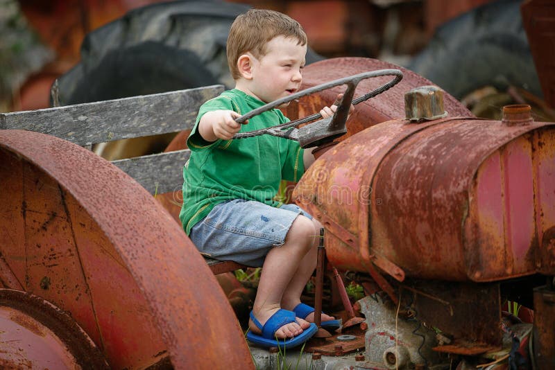 Little boy on a tractor stock photo. Image of childhood 63531642