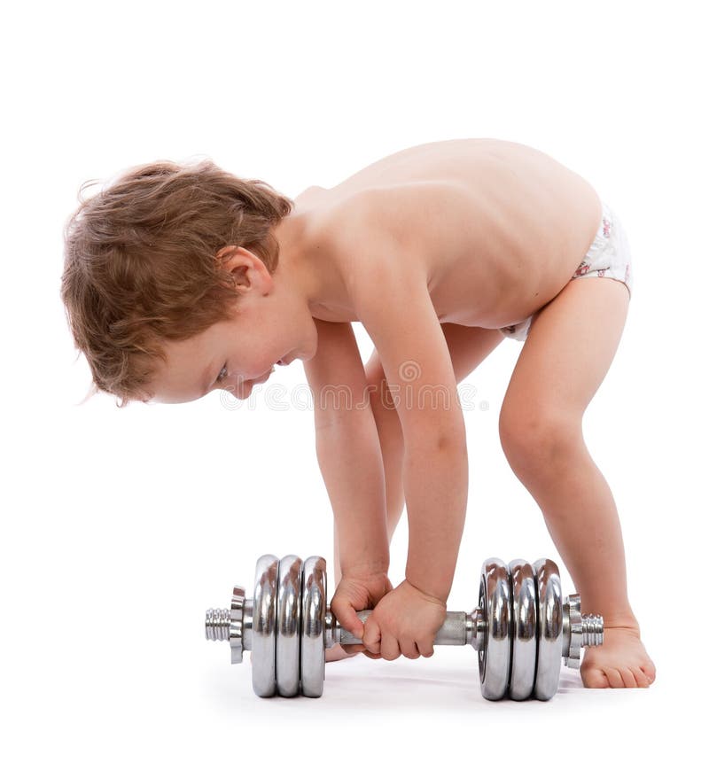 Little boy trying to lift heavy dumbbell