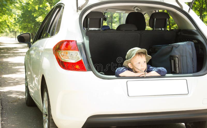 Little boy waiting with his luggage