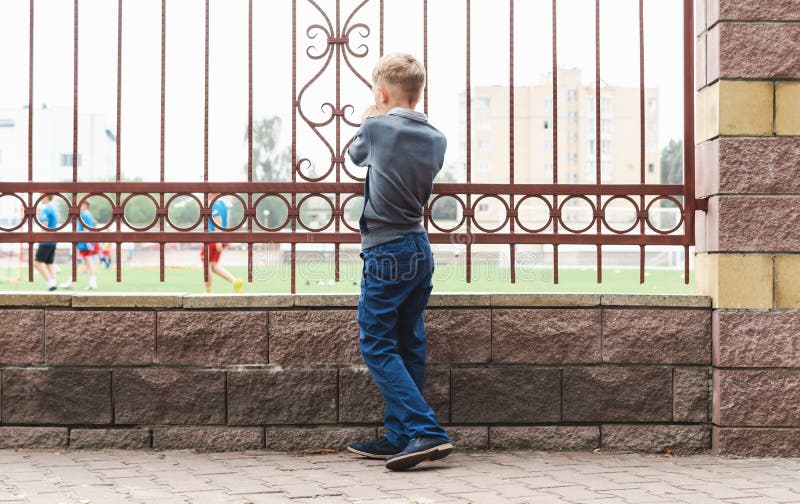 A Little Boy Watches the Stadium Stock Photo Image of action