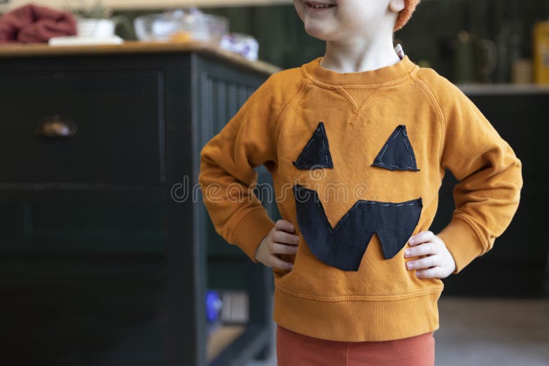 A Little Boy Wearing A Homemade Pumpkin Halloween Costume Stock Image a-little-boy-wearing-a-homemade-pumpkin-halloween-costume-stock-image