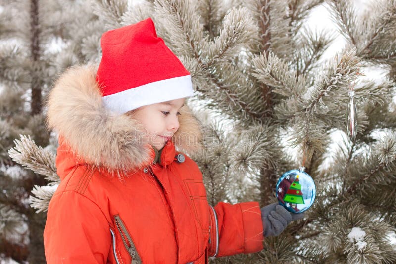 Little boy at the winter walk is decorated with