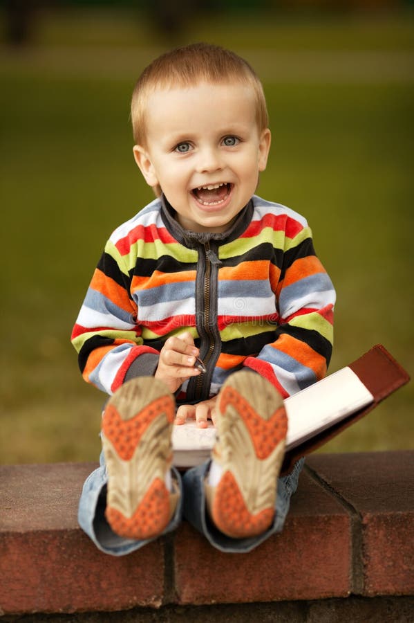 Little boy writes with pen stock photo. Image of notepad 28246630