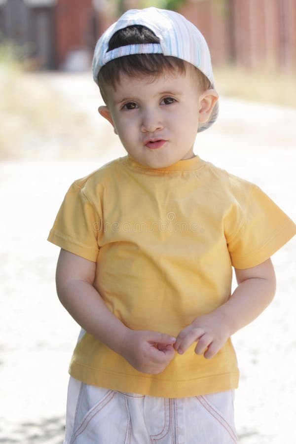 Little Boy in Yellow Shirt and Cap Stock Photo Image of child, yellow 14963084