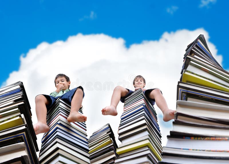 Little boys on large stack of books royalty free stock images Little boys on large stack of books royalty free stock images