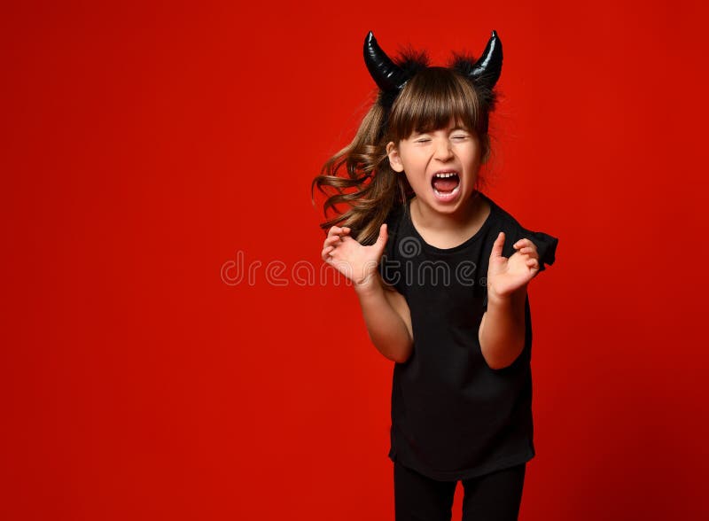 Little Kid with Devil Horns, in Black Blouse and Leggings Screaming ...