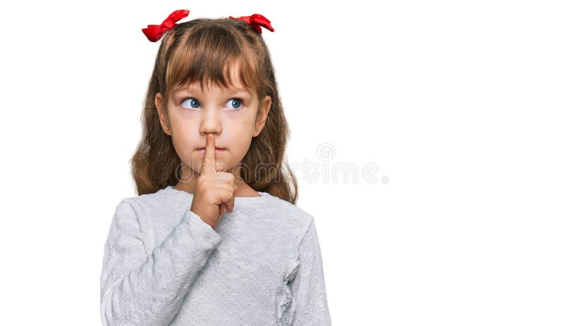 Little caucasian girl kid wearing casual clothes asking to be quiet with finger on lips