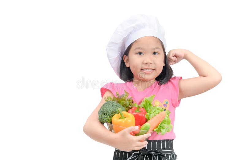 Little chef holding vegetables and show muscle royalty free stock image Little chef holding vegetables and show muscle royalty free stock image