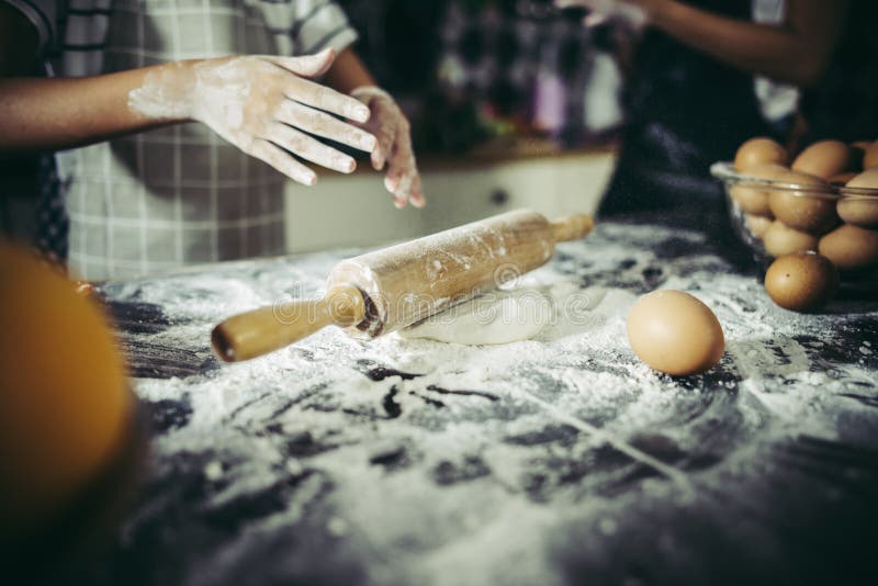 Little Chef Using Rolling Pin Stretching the Dough. Stock Photo Image