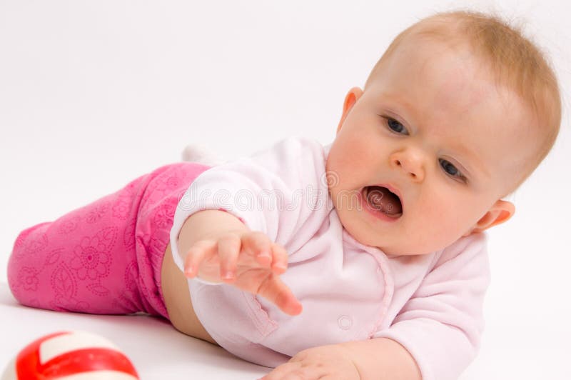 Little child baby crawling for the ball