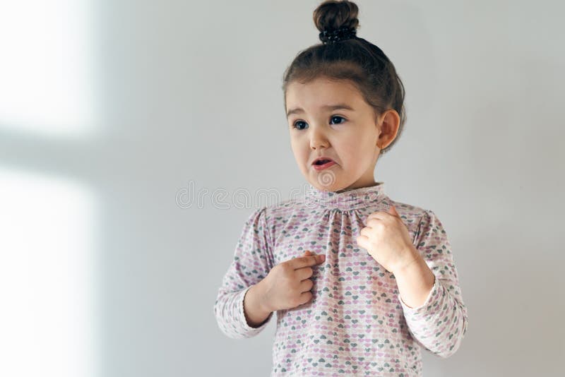 Little Child Baby Girl with Her Hair Gathered in a Bun on Top Upset and Outraged by the Injustice. Stock Image - Image of face, pensive: 111011027 Little Child Baby Girl with Her Hair Gathered in a Bun on Top Upset and Outraged by the Injustice. Stock Image - Image of face, pensive: 111011027