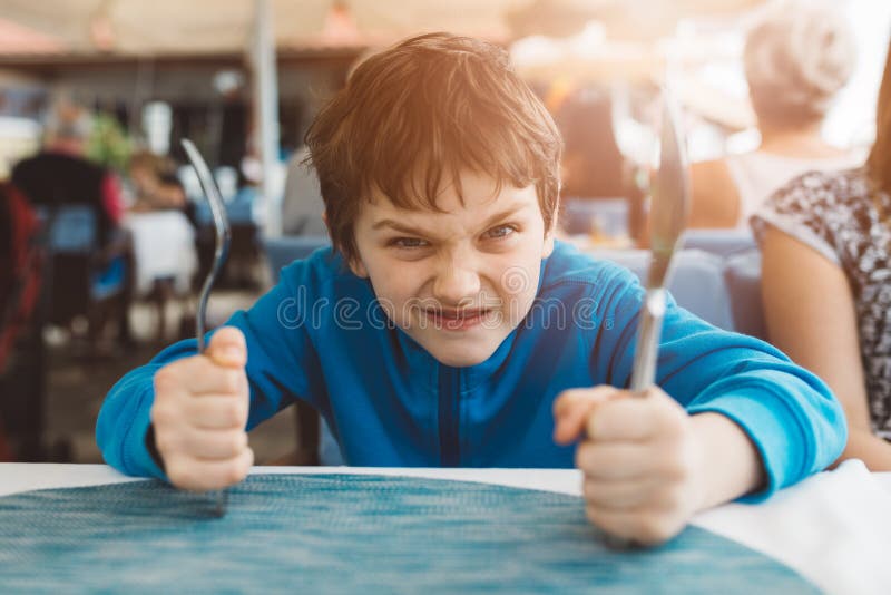 Little child boy hungry waiting for dinner in restaurant stock photos Little child boy hungry waiting for dinner in restaurant stock photos