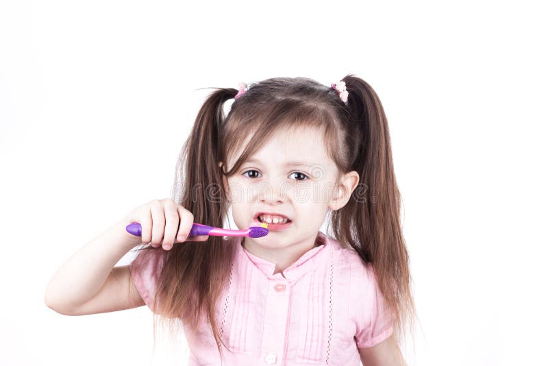 Little Child Brushes Her Teeth, Isolated on a White Background Stock