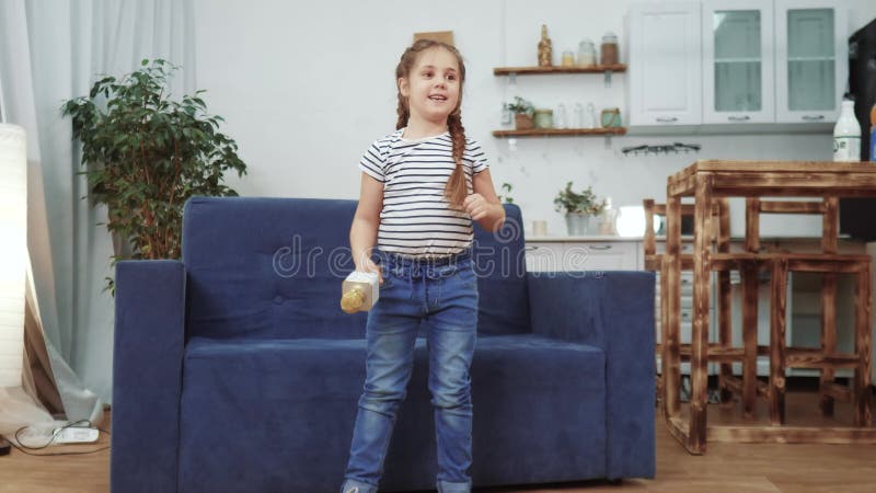 Little child daughter a sing dancing at home. stay home active leisure happy childhood concept. child daughter dancing