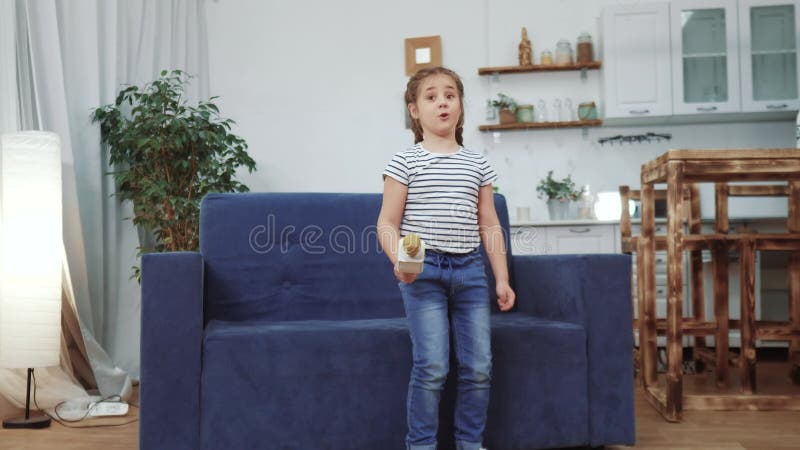 Little child daughter a sing dancing at home. stay home active leisure happy childhood concept. dream child daughter