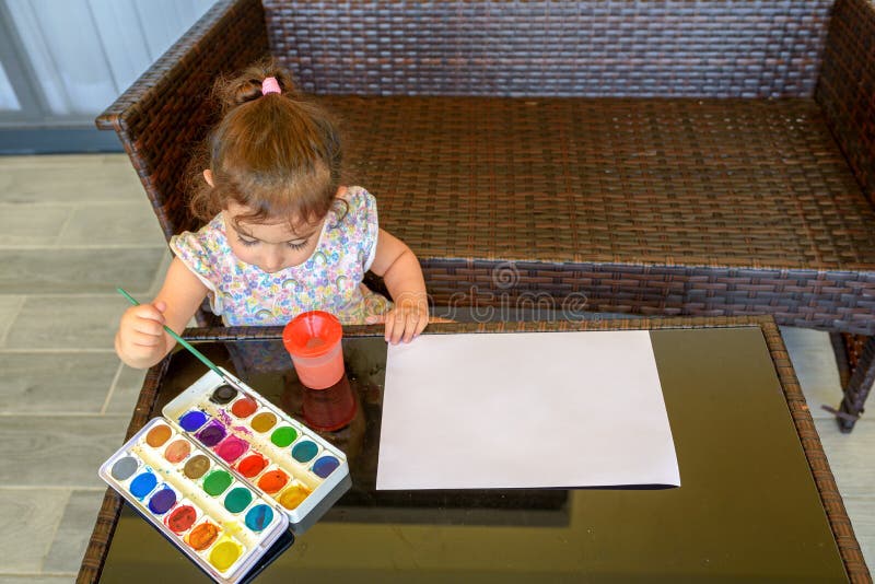 Cute little girl painting picture on home interior background. Summer fun. royalty free stock image Cute little girl painting picture on home interior background. Summer fun. royalty free stock image