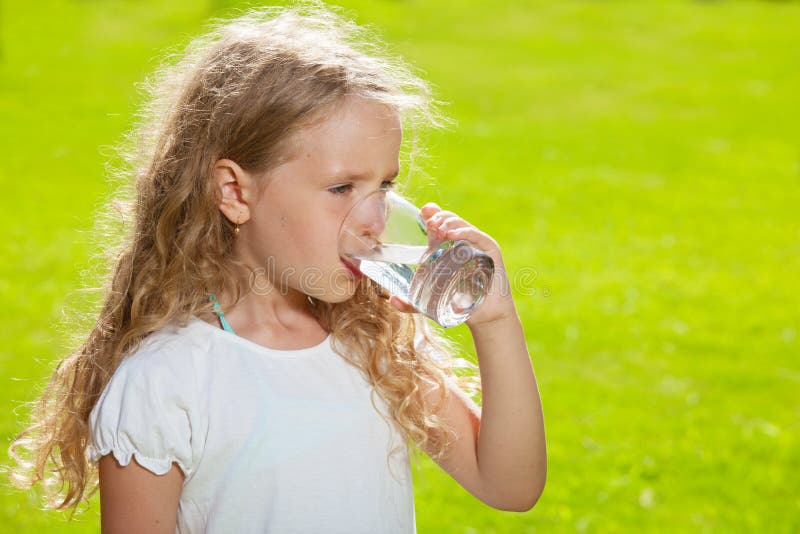 Boy and Girl Drinking Juice from Glass Stock Photo Image