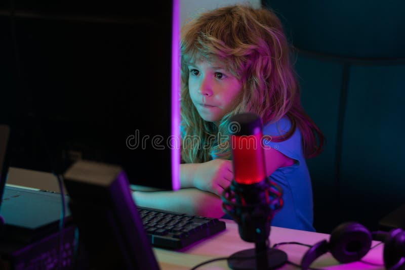 Young girl playing video games on computer after online school and  homework. Gamer using shooting action play for entertainment and fun with  keyboard and monitor. Child enjoying game Stock Photo - Alamy