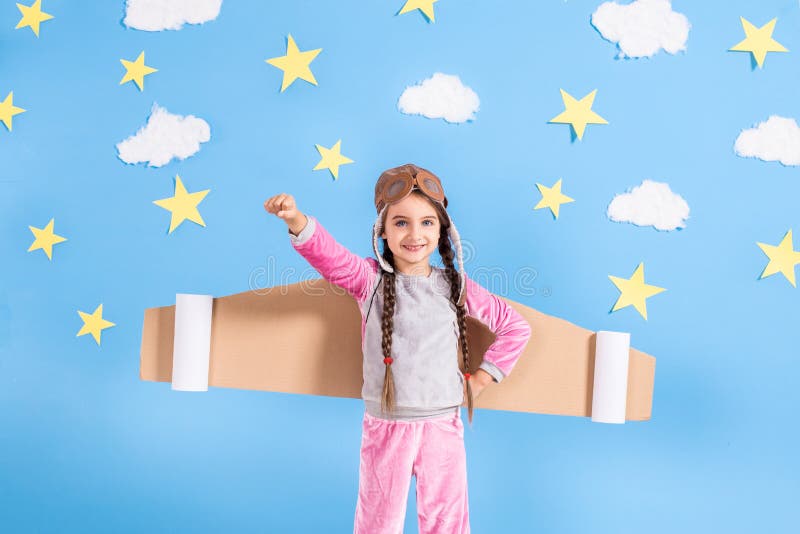 Little child girl in an astronaut costume is playing and dreaming of becoming a spaceman. royalty free stock image Little child girl in an astronaut costume is playing and dreaming of becoming a spaceman. royalty free stock image