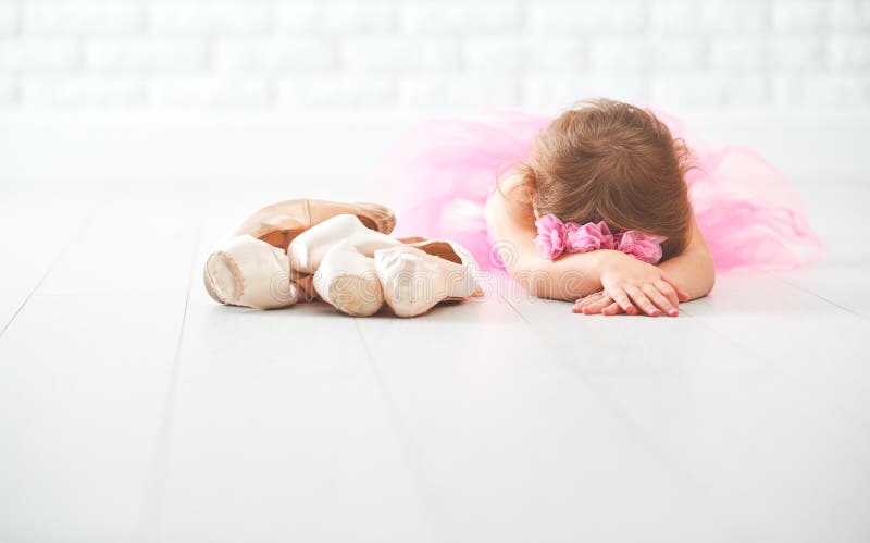 Little child girl ballerina with ballet shoes and pointe shoes