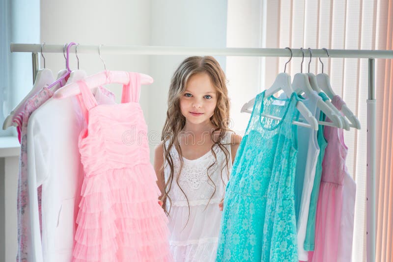 https://thumbs.dreamstime.com/b/little-child-girl-choosing-her-clothes-kid-thinking-what-to-choose-wear-front-many-choices-dresses-hangers-sales-buy-218178614.jpg