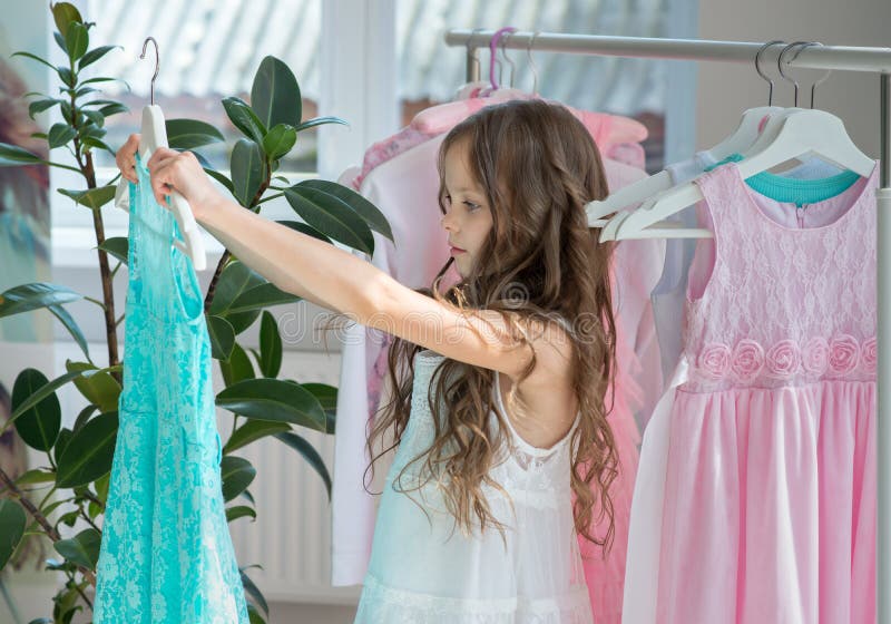 https://thumbs.dreamstime.com/b/little-child-girl-choosing-her-clothes-kid-thinking-what-to-choose-wear-front-many-choices-dresses-hangers-sales-buy-218178620.jpg