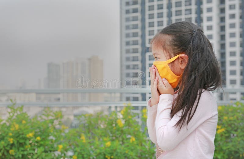 Little child girl wearing a protection mask against PM 2.5 air pollution in Bangkok city. Thailand