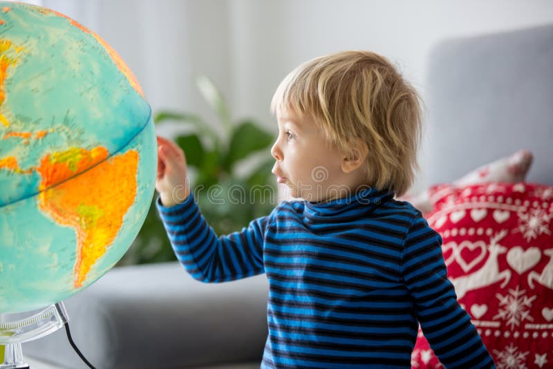 Little Child, Looking at Illuminated Globe, Exploring Stock Photo 