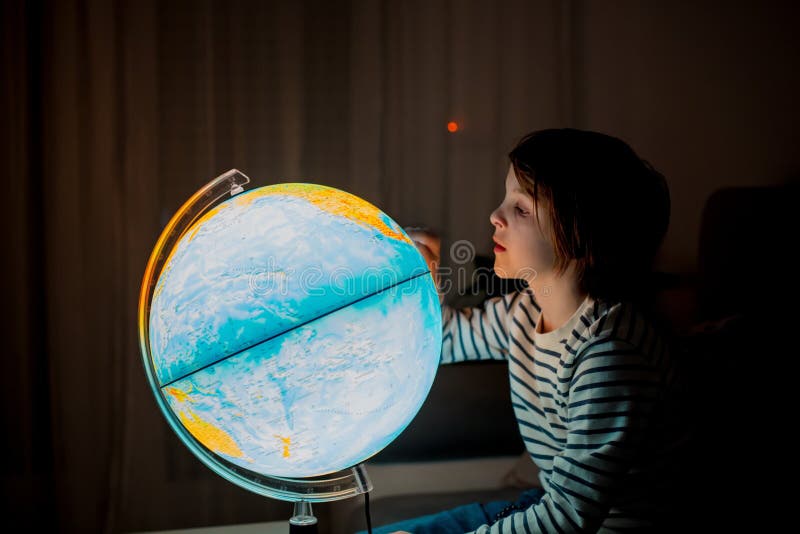 Little Child, Looking at Illuminated Globe, Exploring Stock Photo 