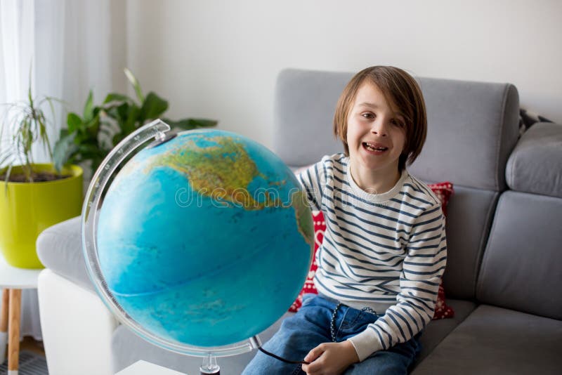 Little Child, Looking at Illuminated Globe, Exploring Stock Photo 