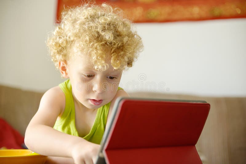 A Little Child Playing with a Tablet Stock Photo Image of little